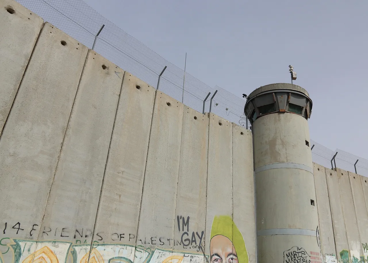 The Israeli separation wall on the northern edge of Bethlehem, with watchtower and concrete barrier visible against the sky