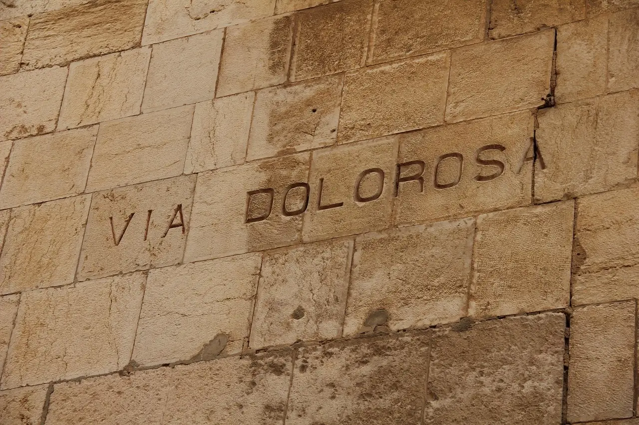 Pilgrims walking the narrow streets of the Via Dolorosa in Jerusalem's Old City